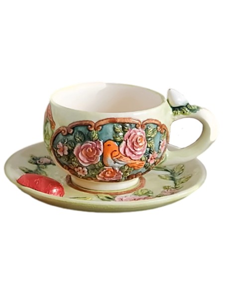 teacup and saucer with embossed motifs