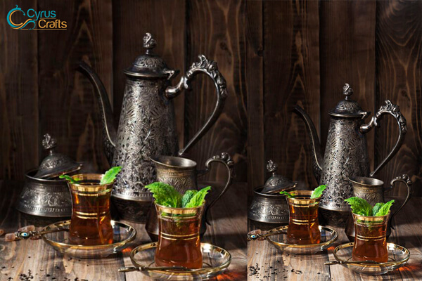 Persian tea in glass cups and metal hand engraving teapot